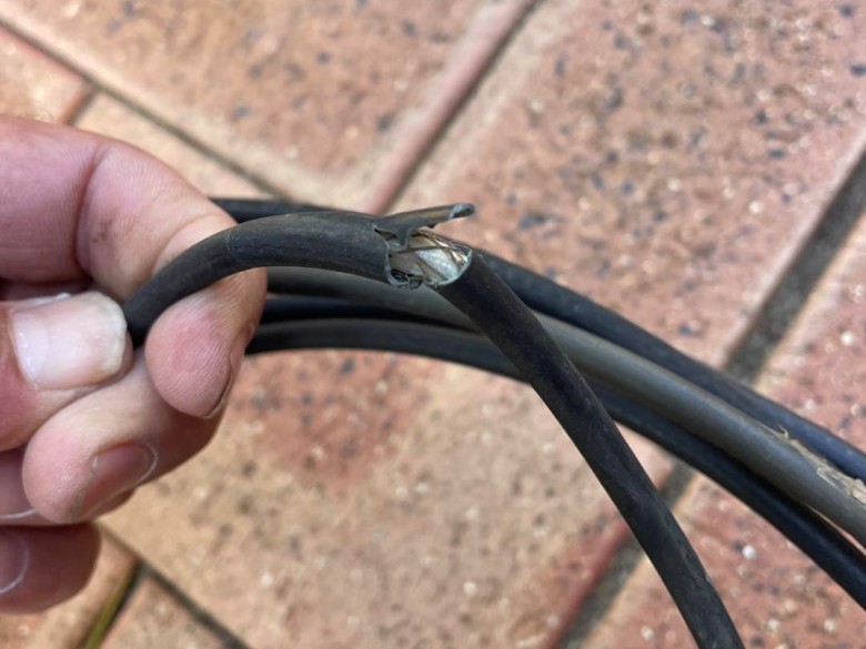 broken cable cover showing exposed wires
